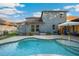 Backyard pool with brick pavers, AC, sun umbrella, and the home's exterior at 30647 Walker Cup Pl, Wesley Chapel, FL 33543