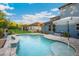 Outdoor pool, fenced-in yard and brick patio with lounge furniture at 30647 Walker Cup Pl, Wesley Chapel, FL 33543