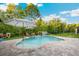 Beautiful in-ground pool surrounded by lush landscaping and a backyard oasis at 30647 Walker Cup Pl, Wesley Chapel, FL 33543