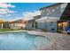 Sparkling in-ground pool with brick patio and lush landscaping, perfect for outdoor relaxation at 30647 Walker Cup Pl, Wesley Chapel, FL 33543