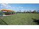 Large fenced dog park with covered seating, providing a safe and enjoyable space for pets and their owners at 31764 Griffin Sands Ln, San Antonio, FL 33576