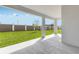 Spacious covered back porch with a view of the backyard and privacy fence at 31764 Griffin Sands Ln, San Antonio, FL 33576