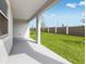 Covered back porch overlooking the well-manicured lawn and fence at 31764 Griffin Sands Ln, San Antonio, FL 33576