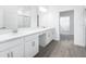 Bright bathroom featuring double sink vanity with quartz countertops and modern fixtures at 31764 Griffin Sands Ln, San Antonio, FL 33576