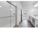 Modern bathroom featuring tiled walk-in shower and double sink vanity with quartz countertops at 31764 Griffin Sands Ln, San Antonio, FL 33576