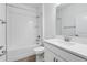 Bright bathroom features a shower-tub combo and a sleek vanity with white quartz countertop at 31764 Griffin Sands Ln, San Antonio, FL 33576