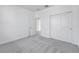 A simple bedroom features neutral carpet, closet with sliding doors, and plenty of natural light at 31764 Griffin Sands Ln, San Antonio, FL 33576