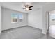 This bedroom features plush carpet, a ceiling fan, and natural light from its two windows at 31764 Griffin Sands Ln, San Antonio, FL 33576