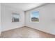 Bright bedroom with two windows and wood-look tile flooring at 31764 Griffin Sands Ln, San Antonio, FL 33576