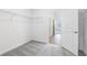 Carpeted closet with metal shelving, white walls, and open doorway to a hallway with light wood floors at 31764 Griffin Sands Ln, San Antonio, FL 33576