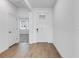 Bright foyer with white walls, white door, and wood-look flooring at 31764 Griffin Sands Ln, San Antonio, FL 33576