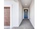 View of front door and garage entrance with stone paved walkway at 31764 Griffin Sands Ln, San Antonio, FL 33576