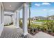 Covered front porch with stone pillars and a view of the landscaped front yard at 31764 Griffin Sands Ln, San Antonio, FL 33576