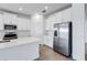 Bright kitchen features white cabinets, stainless steel appliances, and quartz countertops at 31764 Griffin Sands Ln, San Antonio, FL 33576