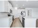 Bright kitchen features modern, white cabinetry, stainless steel appliances, and luxury vinyl flooring at 31764 Griffin Sands Ln, San Antonio, FL 33576