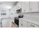Modern kitchen featuring white cabinets, quartz countertops, and stainless steel appliances at 31764 Griffin Sands Ln, San Antonio, FL 33576