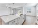 Bright kitchen features a spacious island with quartz countertops and stainless steel appliances at 31764 Griffin Sands Ln, San Antonio, FL 33576