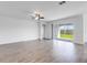 Bright living room features luxury vinyl plank flooring and sliding door to a backyard at 31764 Griffin Sands Ln, San Antonio, FL 33576