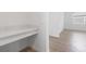 Office nook with a built in desk area, wood look tile floor, and a view into the spare bedroom at 31764 Griffin Sands Ln, San Antonio, FL 33576