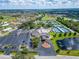 Aerial view of Sun City Center with a full parking lot, lake, and tennis courts at 334 Northway Dr, Sun City Center, FL 33573
