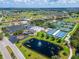 Aerial view of Sun City Center with a lake, tennis courts, and baseball field at 334 Northway Dr, Sun City Center, FL 33573