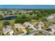 Beautiful aerial view of home nestled in a golf community with mature trees and landscaping at 334 Northway Dr, Sun City Center, FL 33573