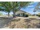 Home's backyard with patio area and surrounding mature trees and landscaping at 334 Northway Dr, Sun City Center, FL 33573