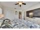 Bedroom featuring ceiling fan, beach-themed decorations, and a dresser with television at 334 Northway Dr, Sun City Center, FL 33573
