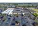 Aerial view showcasing a community center with parking and nearby recreational facilities at 334 Northway Dr, Sun City Center, FL 33573