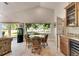 Bright dining area features vaulted ceilings, sliding doors, and a view of the backyard at 334 Northway Dr, Sun City Center, FL 33573