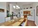 Open dining area with tall ceilings, chandelier, and views into the kitchen at 334 Northway Dr, Sun City Center, FL 33573