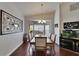 Dining room featuring a chandelier, bay window, and an adjacent fish tank display at 334 Northway Dr, Sun City Center, FL 33573