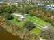 Overhead view of dog park featuring grassy areas, shelters, and walking paths by a lake at 334 Northway Dr, Sun City Center, FL 33573