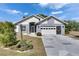 Charming single-story home featuring a two-car garage, beautiful landscaping, and a welcoming entryway at 334 Northway Dr, Sun City Center, FL 33573