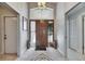 Grand foyer with decorative tile flooring, high ceilings, sidelight windows, and elegant light fixture at 334 Northway Dr, Sun City Center, FL 33573