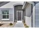Close-up of the front door featuring a decorative glass insert and neutral paint scheme at 334 Northway Dr, Sun City Center, FL 33573
