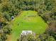 Aerial view of outdoor gun range with multiple targets and a shelter in a wooded area at 334 Northway Dr, Sun City Center, FL 33573