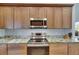 Updated kitchen features stainless steel appliances, granite countertops, and wood cabinets at 334 Northway Dr, Sun City Center, FL 33573