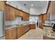 Spacious kitchen with granite countertops, wooden cabinets, and stainless appliances at 334 Northway Dr, Sun City Center, FL 33573