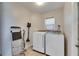 Laundry room with new appliances, ladder, and tile floor at 334 Northway Dr, Sun City Center, FL 33573