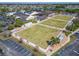 Aerial view showing lawn bowling courts and recreational areas within the community at 334 Northway Dr, Sun City Center, FL 33573