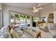 Spacious living room with vaulted ceilings, tile flooring, access to the patio, and backyard views at 334 Northway Dr, Sun City Center, FL 33573