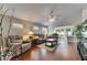 Bright living room with hardwood floors, neutral furniture, and a view of the backyard at 334 Northway Dr, Sun City Center, FL 33573