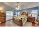 Relaxing main bedroom with tropical bedding, wooden furniture, and a bright, airy feel at 334 Northway Dr, Sun City Center, FL 33573