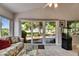 Large sliding glass doors provide views to a well manicured patio, and a lush backyard beyond at 334 Northway Dr, Sun City Center, FL 33573