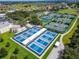 Aerial view of multiple tennis courts and recreation center in Sun City Center at 334 Northway Dr, Sun City Center, FL 33573