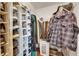 Well-organized walk-in closet featuring shelving and hanging storage for clothes and shoes at 334 Northway Dr, Sun City Center, FL 33573