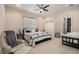 Bright bedroom with a ceiling fan, neutral walls, and comfortable seating at 3607 Berger Rd, Lutz, FL 33548