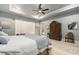 Bedroom featuring a ceiling fan, tray ceilings, and a large window at 3607 Berger Rd, Lutz, FL 33548