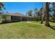 Beautiful home exterior with tile roof, landscaped yard, and outdoor patio at 3607 Berger Rd, Lutz, FL 33548